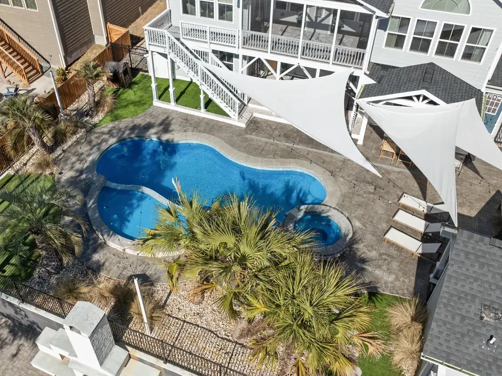 Travertine pool deck and coping after low-pressure cleaning at a home in Ponte Vedra Beach, Florida