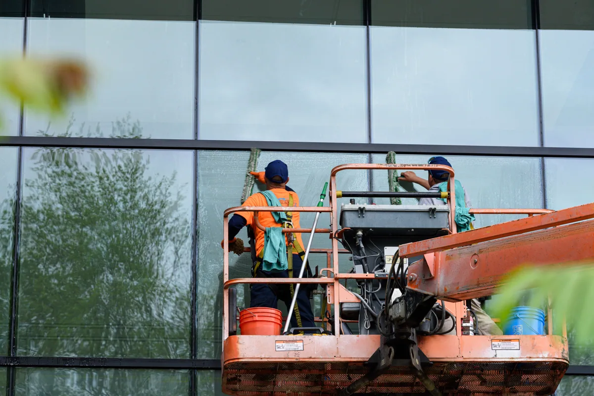Commercial pressure washing crew cleaning a building exterior in Jacksonville, Florida