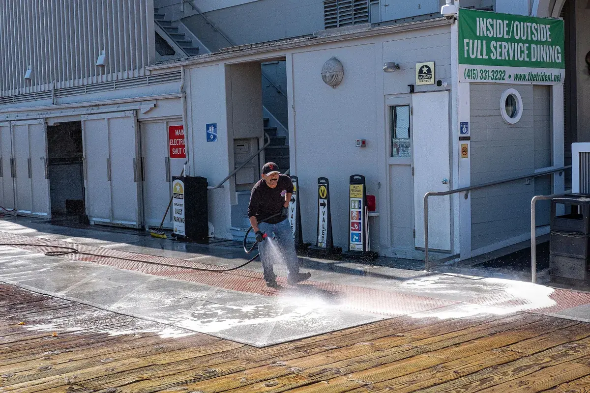 Pressure washing a concrete driveway with a surface cleaner in Jacksonville, Florida